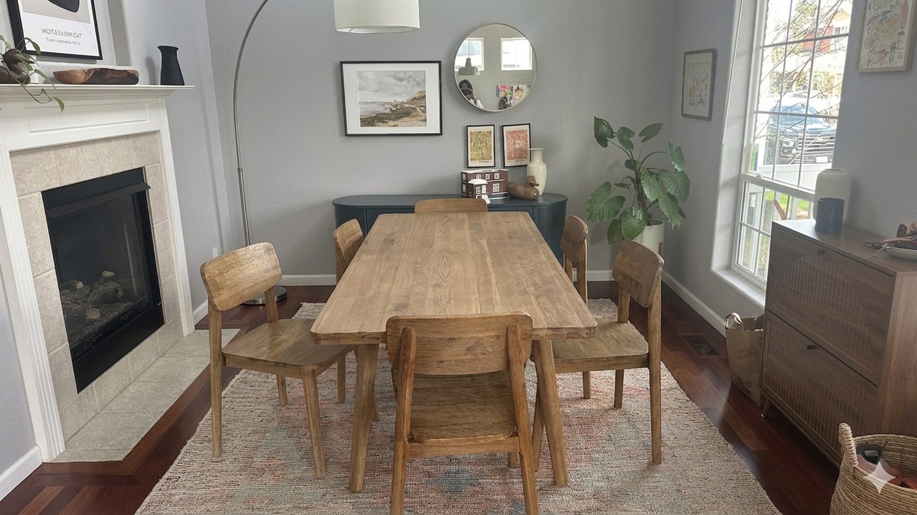 Adjoining dining room and lounge with wood table, fireplace, and layered furnishings